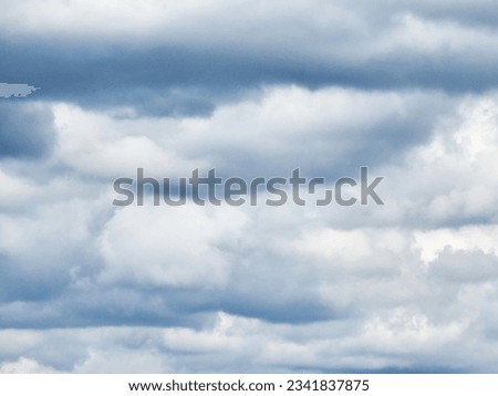 The image of the formidable storm clouds in close-up is sight that commands attention and evokes sense of awe and trepidation. Сlouds loom large, dominating frame with their dark and ominous presence.