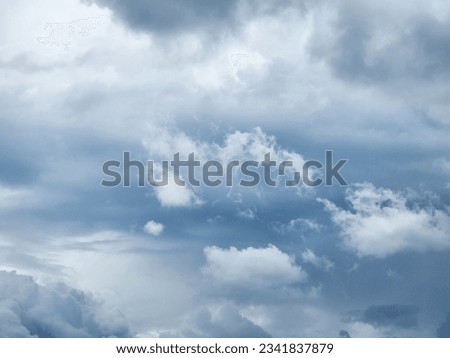 The image of the formidable storm clouds in close-up is sight that commands attention and evokes sense of awe and trepidation. Сlouds loom large, dominating frame with their dark and ominous presence.