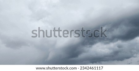 The image of the formidable storm clouds in close-up is sight that commands attention and evokes sense of awe and trepidation. Сlouds loom large, dominating frame with their dark and ominous presence.
