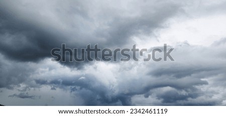 The image of the formidable storm clouds in close-up is sight that commands attention and evokes sense of awe and trepidation. Сlouds loom large, dominating frame with their dark and ominous presence.
