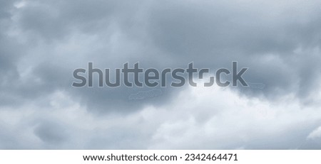 The image of the formidable storm clouds in close-up is sight that commands attention and evokes sense of awe and trepidation. Сlouds loom large, dominating frame with their dark and ominous presence.
