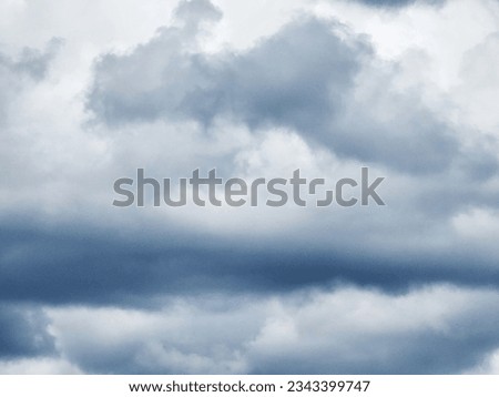 The image of the formidable storm clouds in close-up is sight that commands attention and evokes sense of awe and trepidation. Сlouds loom large, dominating frame with their dark and ominous presence.