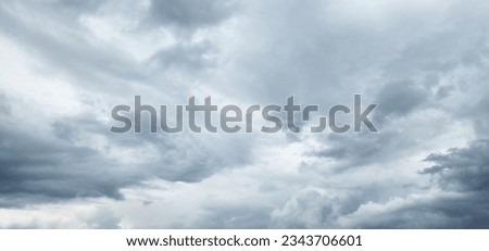 The image of the formidable storm clouds in close-up is sight that commands attention and evokes sense of awe and trepidation. Сlouds loom large, dominating frame with their dark and ominous presence.