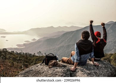 Image of friends who are sitting on top of mountain
