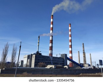 Image of a functioning thermoelectric power station. Smoke from pipes is released into the air. Environmental problems concept.