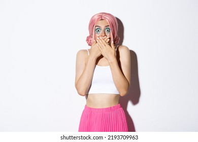 Image Of Girl Smiling And Laughing, Cover Mouth With Hands And Looking At Camera Amused, Standing In Pink Wig And Bright Outfit For Halloween Party