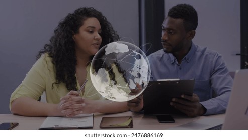 Image of globe and data processing over diverse business colleagues at office. Global communication, data and business network concept digitally generated image.