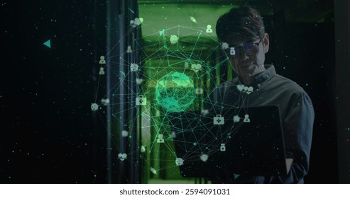 Image of globe and data processing over asian male worker in server room. Global technology and digital interface concept digitally generated image.