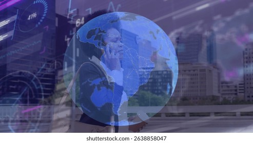 Image of globe and data processing over african american businesswoman talking on smartphone. Global networking and business technology concept