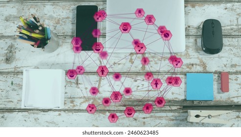 Image of globe of digital icons against close up of equipment on wooden surface. Global networking and business technology concept - Powered by Shutterstock