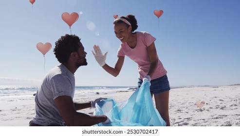 Image of globe icons over happy african american man and woman picking up rubbish from beach. eco conservation volunteers, beach clean-up concept digitally generated image. - Powered by Shutterstock