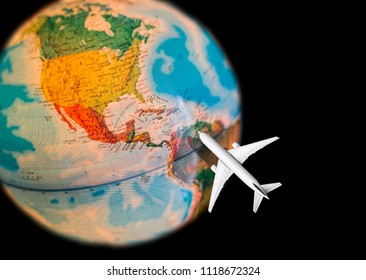 image of the globe shot on the northern hemisphere with northern and southern america with traveling airplane on black background