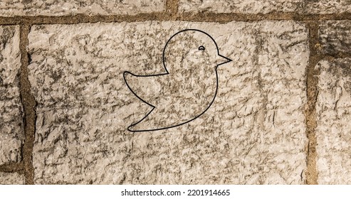 Image of glowing neon bird icon on brick wall. social media and communication concept digitally generated image. - Powered by Shutterstock