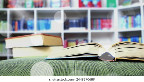 Image of glowing spots of light over books in library. international literacy day and reading concept digitally generated image. - Powered by Shutterstock