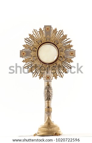 an image of a golden mostrance isolated in white