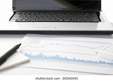 An Image of Graph And Laptop