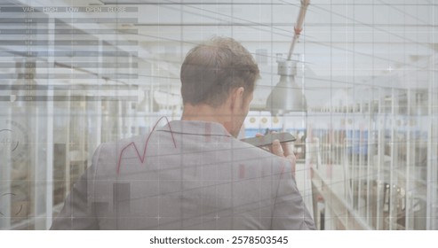 Image of graphs and charts over caucasian businessman talking on smartphone at airport. Business, connection, data, processing, digital interface and communication, digitally generated image.