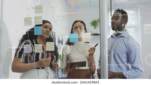 Image of graphs and loading circles over diverse coworkers discussing strategy in office. Digital composite, multiple exposure, report, business, progress, planning and teamwork concept.
