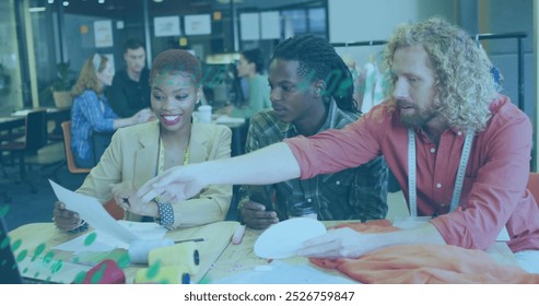 Image of graphs moving over diverse designers choosing from colour swatch at desk. Digital composite, business, report, data, fashion, creative, teamwork, office, planning and technology concept. - Powered by Shutterstock