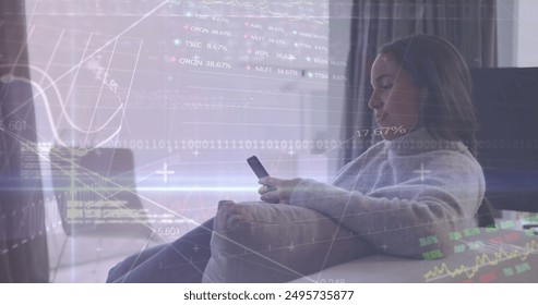 Image of graphs, trading boards, binary codes, biracial woman using smartphone at home. Digital composite, multiple exposure, report, business, stock market, computer language and technology.