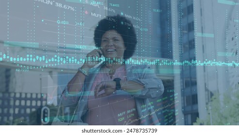 Image of graphs, trading boards, biracial woman talking on cellphone and looking at smartwatch. Digital composite, multiple exposure, report, business, stock market and technology concept. - Powered by Shutterstock