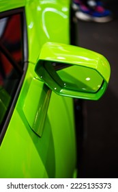 Image of a green sport car side rear view mirror. - Shutterstock ID 2225135373