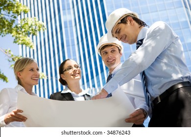 Image Of Group Of Several Workers Planning Their Work Outside