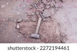 a image of a hammer kept on a surface after the floor is smashed, Construction concept
