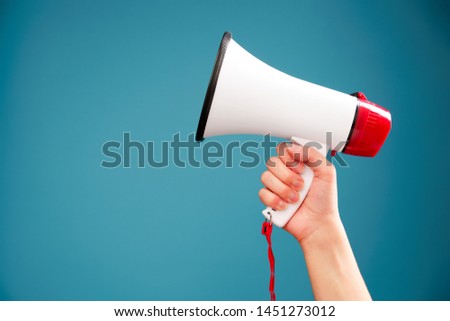 Image of hand with mouthpiece on empty blue background