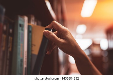 
Image of a hand selecting a book from a bookshelf - Powered by Shutterstock