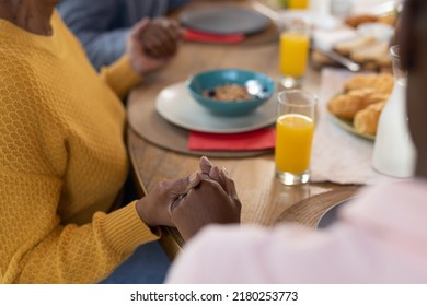 Image Of Hands Of African American Family Praying Before Meal. Family And Spending Quality Time Together Concept.