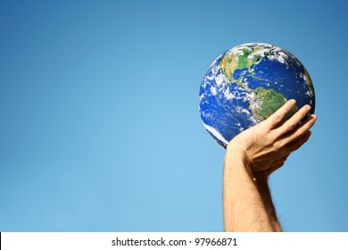 an image of hands holding globe and sky