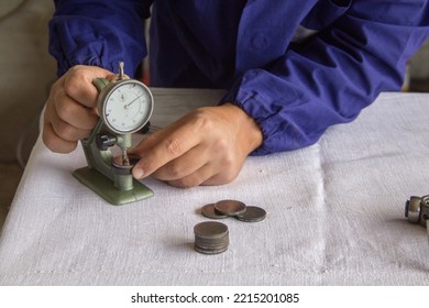 Image of the hands of a mechanic in his workshop who, with a thickness gauge precision instrument, measures mechanical parts. Related to precision mechanics
 - Shutterstock ID 2215201085
