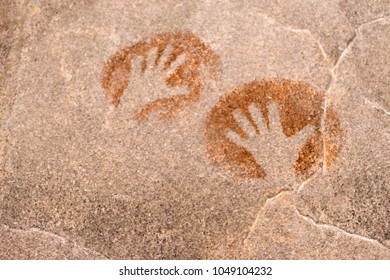 image of hands on the wall of the cave made by an ocher ancient man. history. archeology - Powered by Shutterstock