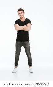 Image Of Handsome Young Man Dressed In Black T-shirt Standing With Arms Crossed Over White Background.