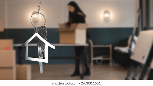 Image of hanging golden house keys against blurred view of woman unpacking boxes. Relocation and real estate concept - Powered by Shutterstock