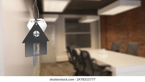 Image of hanging silver house keys against interior of a office conference room. Interior designing and real estate concept - Powered by Shutterstock