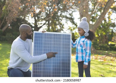 Image of happy african american father showing solar panels to daughter. Family, green energy and eco awareness concept. - Powered by Shutterstock