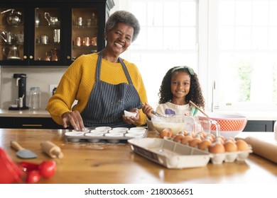 Image Of Happy African American Grandmother And Granddaughter Baking In Kitchen. Family And Spending Quality Time Together Concept.