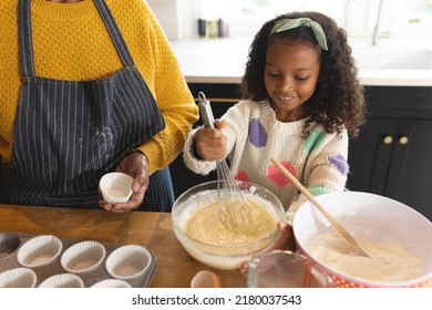 Image Of Happy African American Grandmother And Granddaughter Baking In Kitchen. Family And Spending Quality Time Together Concept.