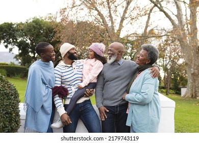 Image Of Happy African American Multi Generation Family In Autumn Garden. Family And Spending Quality Time Together Concept.