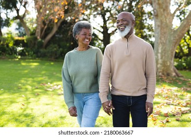 Image of happy african american senior couple in garden. Love, relationship, family and spending quality time together concept. - Powered by Shutterstock