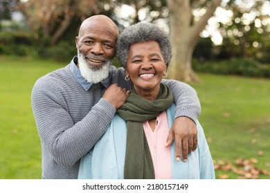 Image of happy african american senior couple posing at camera outdoors in autumn. Family, spending quality time together concept. - Powered by Shutterstock