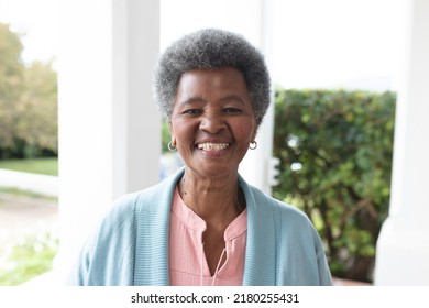 Image of happy african american senior woman posing at camera. Lifestyle and spending time at home and garden concept. - Powered by Shutterstock