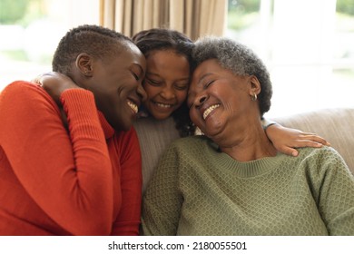 Image of happy african american three generation women sitting on sofa and embracing. Family and spending quality time together concept. - Powered by Shutterstock