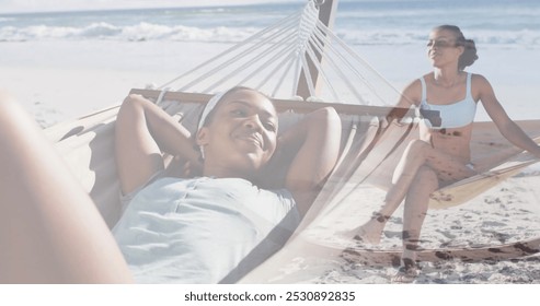 Image of happy african american woman in hammock on beach. Holidays, vacations and relax concept digitally generated image. - Powered by Shutterstock