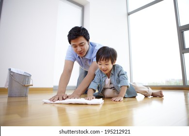 The Image Of A Happy Asian Family Cleaning The Floor