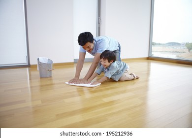 The Image Of A Happy Asian Family Cleaning Floor 