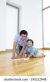 The Image Of A Happy Asian Family Cleaning Floor