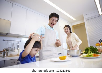 The Image Of A Happy Asian Family Cooking